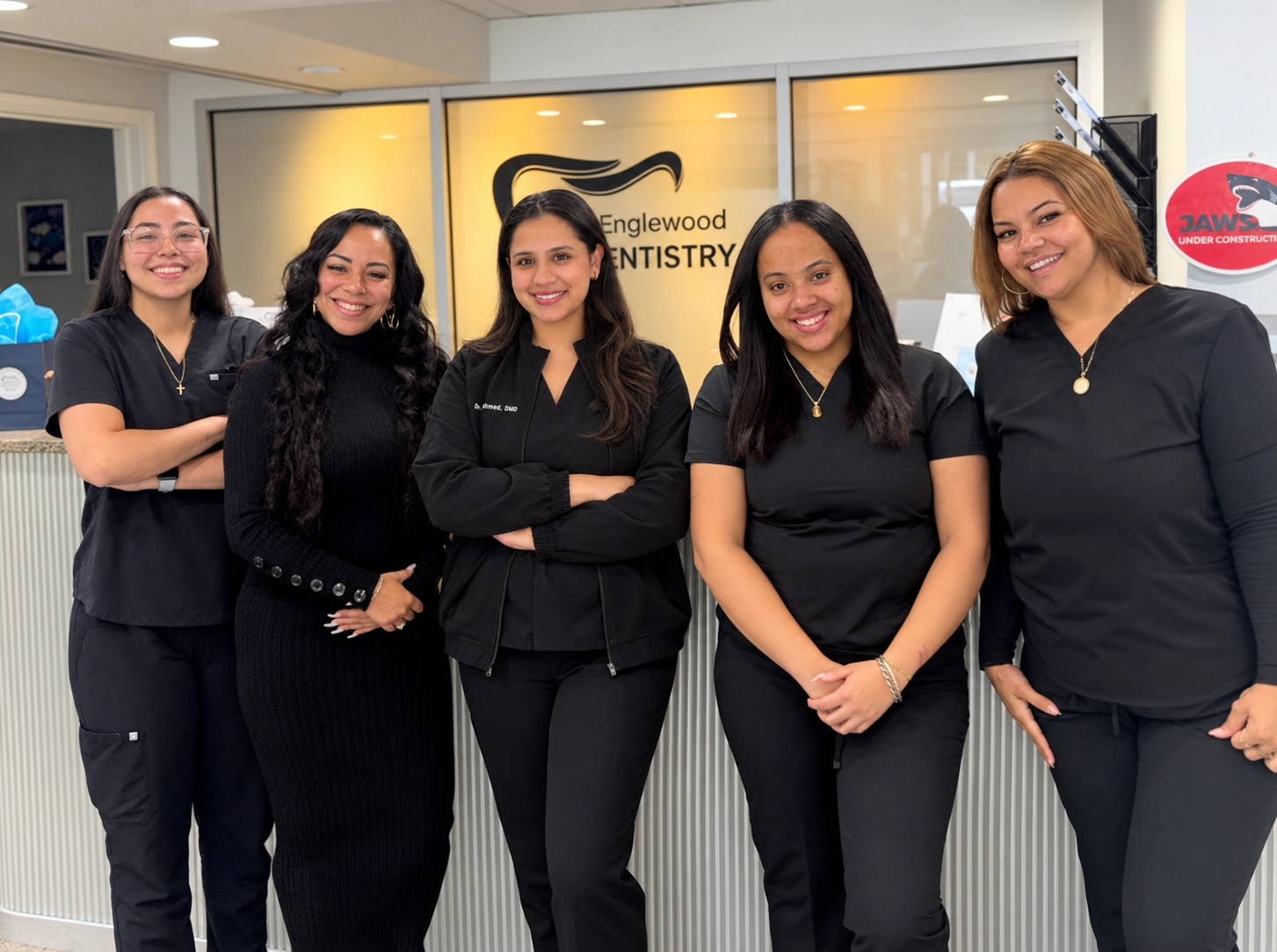 Dr. Iqra Ahmed and the Englewood Dentistry team smiling at reception